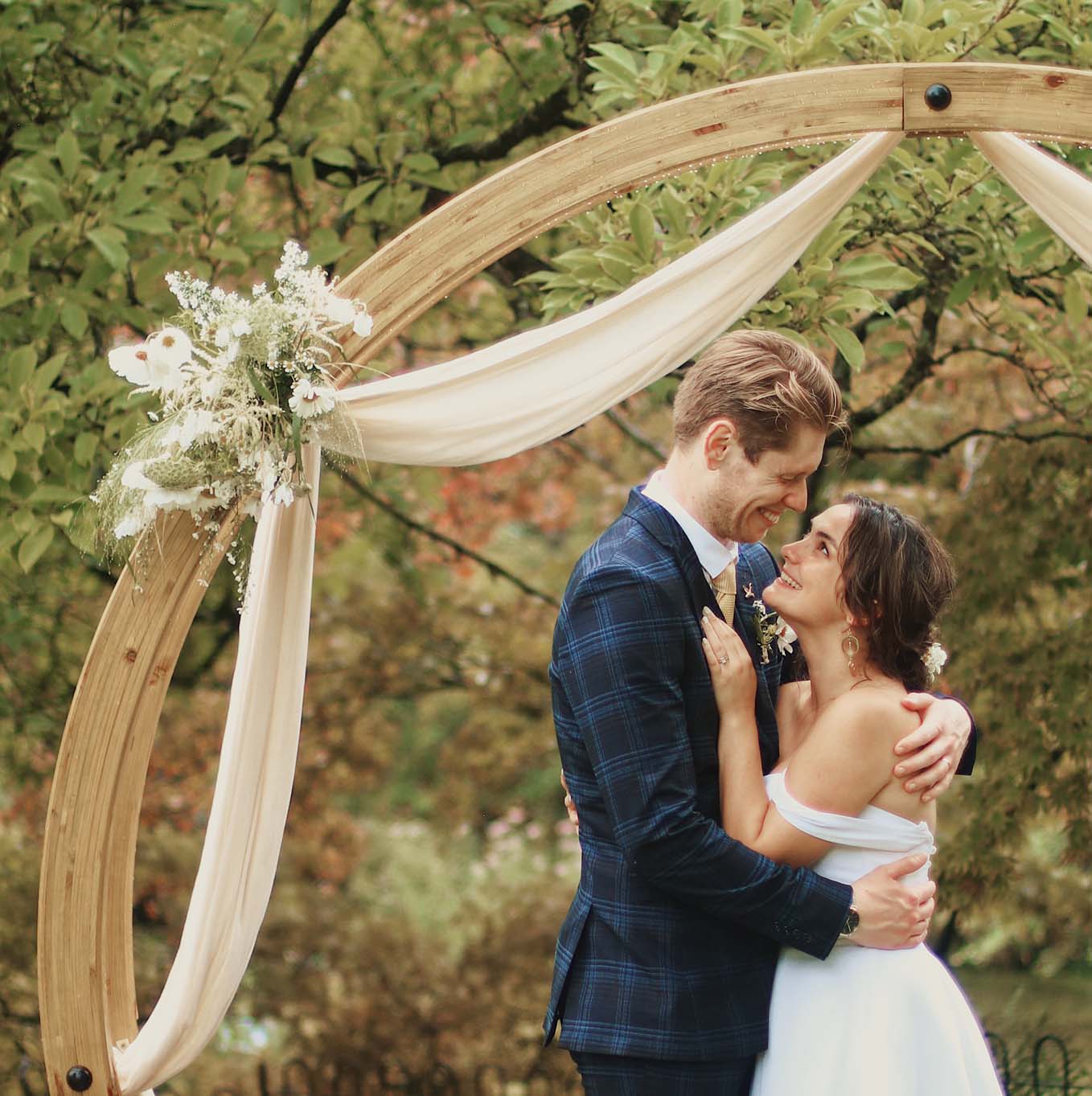 Wedding couple embrace inside the Moongate