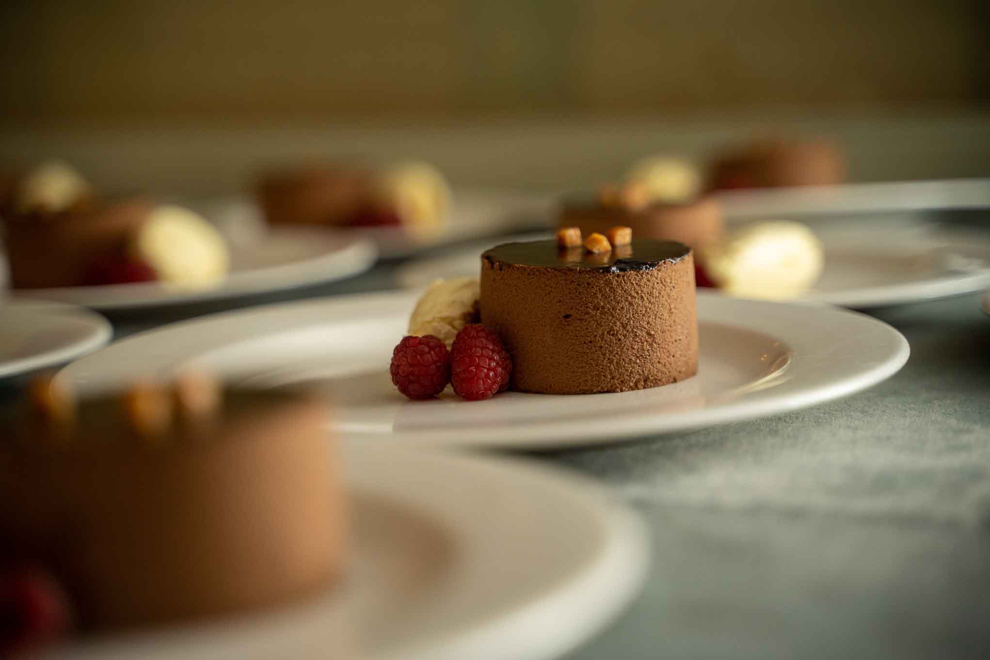 Dessert of chocolate torte with clotted cream and raspberries